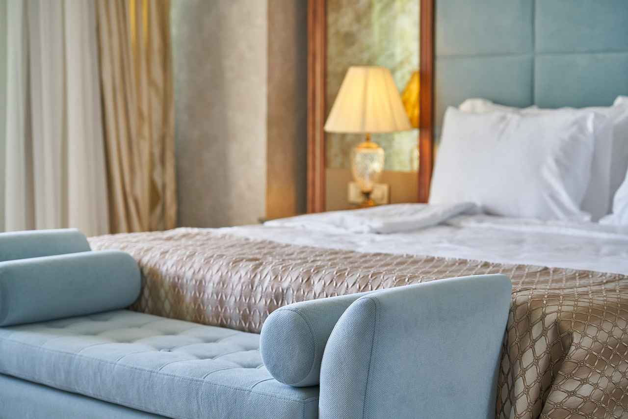 A hotel bedroom with a radiator under the window
